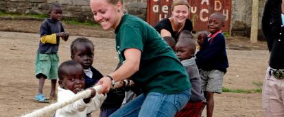Projects Abroad volunteers work with children in Ghana. Childcare volunteer plays a game with children during her work experience in Ghana.